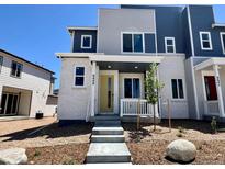 Charming two-story home with a welcoming front porch and professionally landscaped front yard at 6648 N Nepal Ct, Aurora, CO 80019