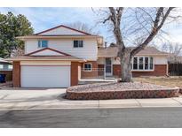 Charming two-story home featuring brick accents, a well-maintained lawn, and an attached two-car garage at 10620 King Ct, Westminster, CO 80031