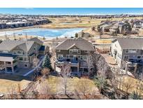 Expansive backyard featuring multi-level deck overlooking green common area, perfect for entertaining at 7680 S Blackstone Pkwy, Aurora, CO 80016