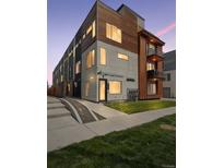 Modern townhome with mixed material facade, including concrete, wood, and metal accents at 1836 Grove St # 108, Denver, CO 80204