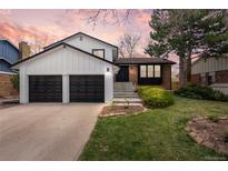 Charming home boasting a well-manicured lawn and a two-car garage, perfectly blending comfort and curb appeal at 7888 S Magnolia Way, Centennial, CO 80112