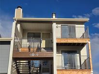 Two-story condo with private balconies and stairwell access to front door, featuring a neutral color scheme at 6009 Yarrow St # C, Arvada, CO 80004