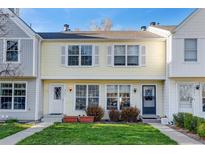 Charming two-story townhouse with well-maintained lawn and inviting curb appeal at 3295 S Estes St, Lakewood, CO 80227