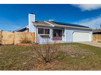 Charming single-Gathering home featuring a well-maintained lawn and solar panels on the roof for energy efficiency at 1451 S Quitman St, Denver, CO 80219