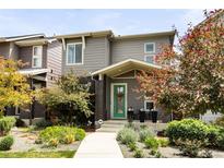 Charming two-story home with well-manicured front yard and inviting green front door at 6654 Pecos St, Denver, CO 80221