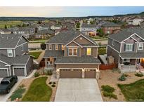 Beautiful two-story home boasts a three-car garage, landscaped yard, and mountain views at 7734 Blue Water Dr, Castle Rock, CO 80108