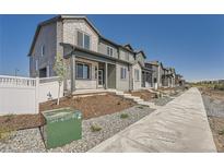 Charming townhomes showcase a blend of stone and siding, with landscaped front yards and concrete walkways at 1294 S Algonquian St, Aurora, CO 80018
