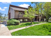 Charming brown townhome featuring a private balcony and lush green lawn at 2630 Juniper Ave # 37-5, Boulder, CO 80304