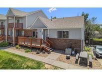 Charming townhome featuring a cozy front deck with seating, a well-maintained lawn, and appealing landscaping at 4220 E 119Th Pl # A, Thornton, CO 80233