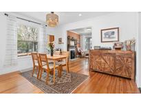Cozy dining room with hardwood floors, natural light, and rustic chandelier at 3059 N Humboldt St, Denver, CO 80205