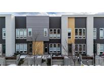 Modern townhome featuring a colorful exterior and concrete steps leading up to the front door at 2870 W Parkside Pl, Denver, CO 80221