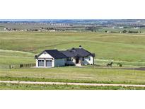 Charming home with a 2-car garage, nice landscaping, and a scenic view of rolling hills at 7600 Patrick Trl, Elizabeth, CO 80107