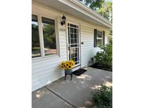 Charming home entrance featuring a decorative door with sunflowers and a welcoming 'Oh, hello' doormat at 1325 S Grape St, Denver, CO 80222