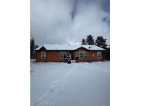 Ranch style home with snowy yard at 10871 Kitty Dr, Conifer, CO 80433