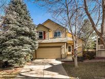 Charming two-story home with well-maintained lawn, mature trees and a two car attached garage at 16118 Peregrine Dr, Parker, CO 80134