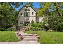 Charming home with a landscaped front yard, brick pathway, and beautiful curb appeal at 141 N Gilpin St, Denver, CO 80218
