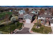Aerial view of two-story home with manicured lawn, mature trees, and neighborhood setting at 6271 Mcintyre Way, Golden, CO 80403