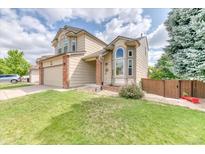 Charming two-story home with a well-manicured lawn and a two-car garage at 5075 Weeping Willow Cir, Highlands Ranch, CO 80130