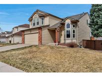 Attractive two-story home with brick accents, a two-car garage, and a landscaped yard at 5075 Weeping Willow Cir, Highlands Ranch, CO 80130