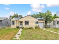 Charming single-story home features a well-maintained front lawn, and solar panels at 1708 Akron St, Aurora, CO 80010