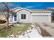 Gray house with two-car garage, and a small front yard at 3564 S Jebel Cir, Aurora, CO 80013