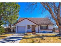 Charming home featuring a well-kept lawn, and a single-car garage at 3000 S Newland St, Denver, CO 80227