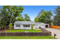 Charming single-story home with a fenced yard and detached garage, perfect for families at 4912 Indiana St, Golden, CO 80403