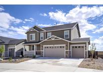 Two-story home showcasing a spacious three-car garage, covered porch, and modern architectural details at 188 S Waterloo St, Aurora, CO 80018