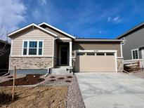 Charming single-Gathering home featuring stone accents, a two-car garage and freshly landscaped front yard at 24739 E 39Th Ave, Aurora, CO 80019
