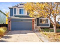 Inviting two-story home featuring a blue exterior, brick accents, well-kept lawn, and a spacious two-car garage at 11525 Eaton Ct, Westminster, CO 80020