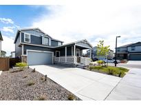 Charming two-story home with a covered porch and well-maintained front yard with a large drive at 3722 Sandy Vista Trl, Castle Rock, CO 80104