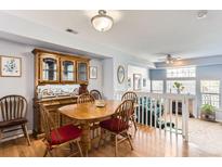 Bright dining room featuring hardwood floors, a wooden table, and view to living area at 8199 Welby Rd # 3102, Denver, CO 80229