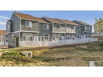Row of townhomes with fenced yards and pleasant landscaping at 8199 Welby Rd # 3102, Denver, CO 80229