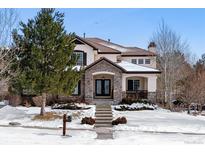 Two-story house with stone accents and a landscaped yard at 24237 E Glasgow Cir, Aurora, CO 80016