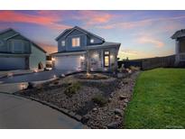 Charming two-story home featuring manicured front yard landscaping and an attached two-car garage at 19840 Glendale Ln, Parker, CO 80134