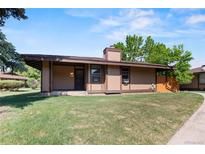 Charming single story house with a covered porch and lush green lawn at 3720 S Fairplay Way, Aurora, CO 80014