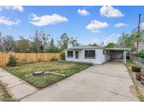 Charming single-story home with a well-maintained front yard, a carport and a newly constructed wooden fence at 7760 Magnolia St, Commerce City, CO 80022