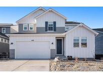 Charming two-story home with a well-manicured yard, a two-car garage, and a welcoming front porch at 3589 Rucksack Ct, Castle Rock, CO 80108