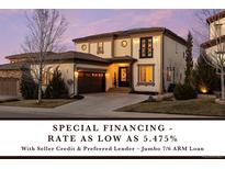 Elegant two-story home featuring a well-manicured lawn, attached garage, and stylish architectural details at 10468 Ladera Dr, Lone Tree, CO 80124