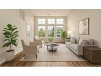 Bright living room features large windows, hardwood floors, and neutral decor at 9633 E 5Th Ave # 10304, Denver, CO 80230