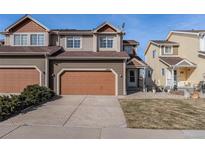 Charming townhome with two-car garage, neutral colors, and well-maintained landscaping at 1405 Willow Oak Rd, Castle Rock, CO 80104
