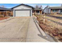 Charming single-Gathering home with a spacious driveway and a well-maintained front yard at 16841 E Mansfield Cir, Aurora, CO 80013