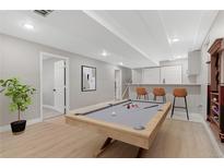 Finished basement featuring a pool table, bar area, and recessed lighting at 12992 W Jewell Cir, Lakewood, CO 80228