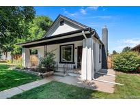 Charming home with landscaped front yard, stone accents, and inviting front porch at 3147 W 39Th Ave, Denver, CO 80211