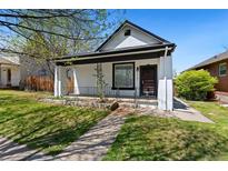 Charming single-story home with a quaint front porch, landscaped garden, and inviting curb appeal at 3147 W 39Th Ave, Denver, CO 80211