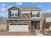 Beautiful two-story home featuring stone accents, neutral siding, and a two-car garage at 4028 N Rome St, Aurora, CO 80019