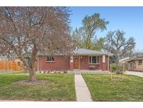 Charming brick home with a well-maintained lawn and mature tree in a desirable neighborhood at 7470 Quitman St, Westminster, CO 80030