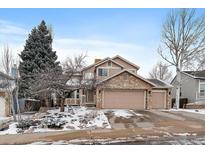Charming two-story home with stone accents and a three car garage at 14335 W Wesley Cir, Lakewood, CO 80228
