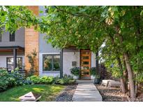 Contemporary two-story home featuring a wood door, xeriscape yard, and modern design at 3168 W 29Th Ave, Denver, CO 80211
