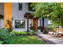 Contemporary home with a well-manicured lawn, tasteful landscaping, and a welcoming, partially-glass front door at 3168 W 29Th Ave, Denver, CO 80211